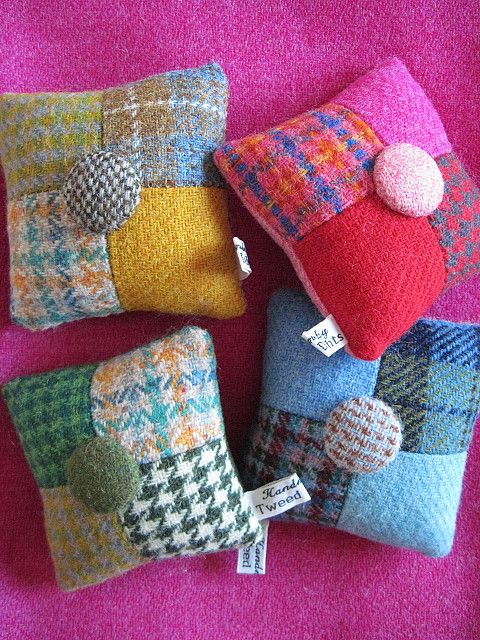 Handmade tweed patchwork pincushions with button centres on a bright pink background
